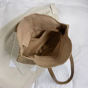 Handmade woven straw beach tote with zipper closure and spacious interior pockets