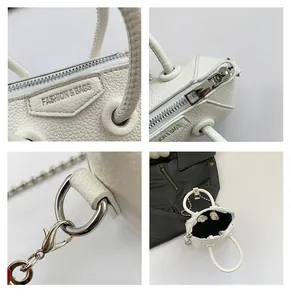 Detail view of white lychee leather mini bag with silver chain and FASHION & BAGS logo