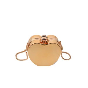 Golden heart-shaped metal clutch bag with bee clasp and slender snake chain strap