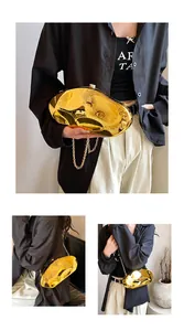 Detailed view of the gold liquid metal evening clutch with a fine chain strap
