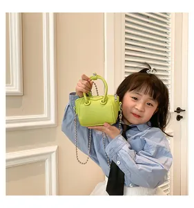Detailed macro of kids mini lime green tote bag featuring luxury lychee texture leather