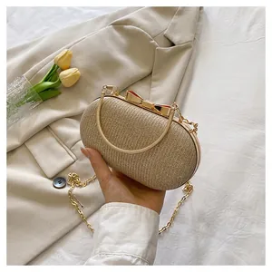 Close-up of glitter evening bag with gold metal bow clasp and delicate chain strap
