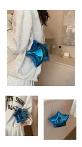 Close-up of bright blue star-shaped bag with mirror finish and gold chain strap