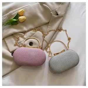 Detail view of pink and silver glitter evening bags with golden metal bow clasps