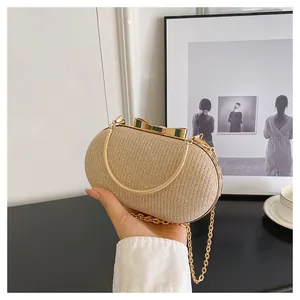 Detail of champagne gold glitter clutch bag with bow clasp and elegant chain straps