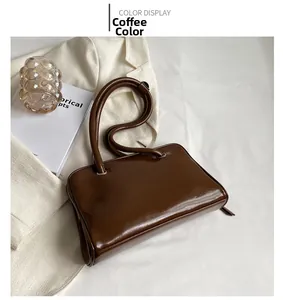 Detailed overhead view of coffee brown shoulder bag with shiny faux leather texture
