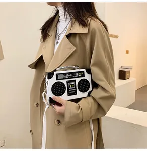 Detailed view of white retro radio shaped handbag with metallic handle and boom text