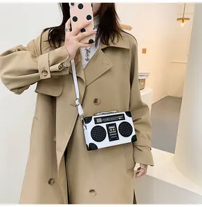 Macro shot of creative retro radio-shaped crossbody bag with realistic speaker and dial details