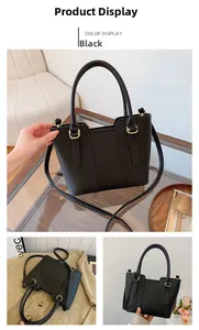 Close-up of black lychee grain leather tote bag with gold-tone hardware detail