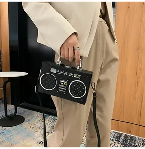 Detail of creative vintage radio shape shoulder bag with realistic speaker grill texture