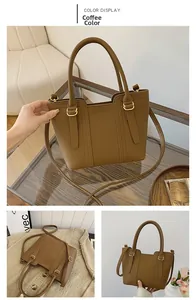 Detail view of coffee-colored leather tote bag with lychee texture and gold hardware