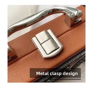 Close-up of brown Saffiano leather texture and silver metal push-lock on handbag