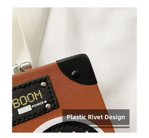 Macro shot of radio box bag with plastic rivet design and boom power embroidery