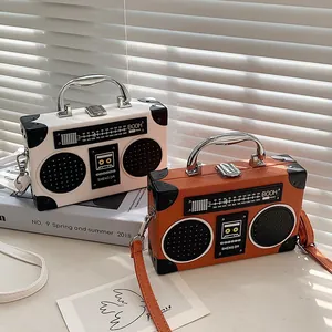Vintage boombox style crossbody bag with retro radio design and metallic top handle