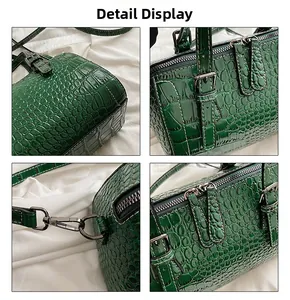 Detalles del bolso verde oscuro con textura de cocodrilo y cremalleras metálicas