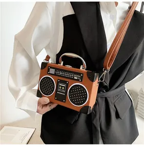 Macro view of vintage boombox-shaped handbag with leather texture and silver hardware