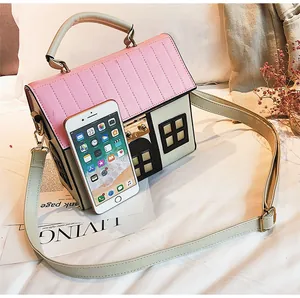 Creative small house shaped crossbody bag in pink and off-white with mobile size reference
