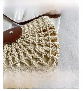 Détail du tissage ajouré et du rabat en cuir marron avec des clous en métal argenté