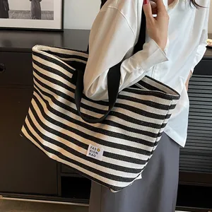 Minimalist black and white striped canvas tote bag for women with fashion rag label