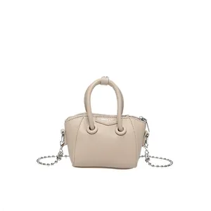 Mini beige pebble leather handbag with silver chain strap and top handles for women