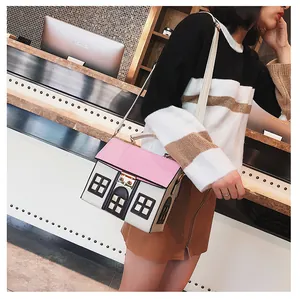 Detail of creative house-shaped crossbody bag with pink striped roof and white PU leather