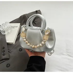 Détail du sac nuage argenté plissé avec poignée en perles marbrées et chaîne