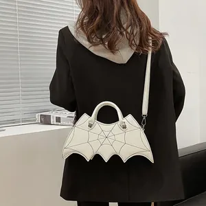 White bat-shaped crossbody bag with spider web embroidery and metal handle for women