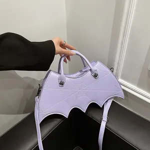 Detail of lavender bat-shaped crossbody bag with spider web stitching and silver hardware