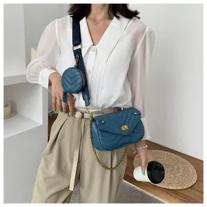 Détail du sac bandoulière matelassé bleu marine avec chaîne dorée et petit porte-monnaie