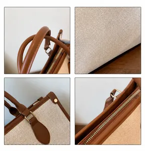 Detail view of canvas tote bag with leather trim, metal zipper and embroidery