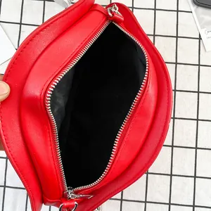Red mushroom crossbody bag with top zipper and black lining shown on checkered background
