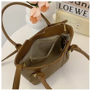 Top view of brown lychee leather bucket bag interior with golden zipper and fabric lining