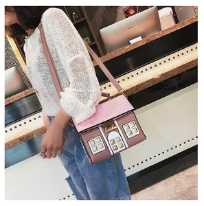 Detailed house-shaped crossbody bag in pink and brown with leather window patches