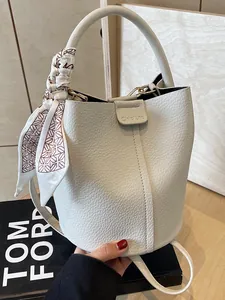 White bucket bag with lychee texture and silk scarf decoration for 2024 spring fashion