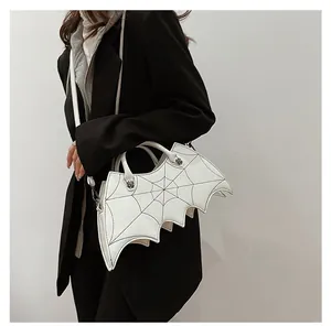 Detail of white PU leather bat-shaped bag with black spider web stitching and silver hardware