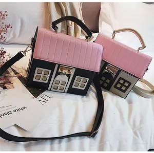 Detail of house-shaped crossbody bags with pink quilted roof and window appliques