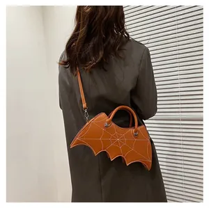 Detail view of gothic bat-shaped handbag with spider web embroidery and shoulder strap