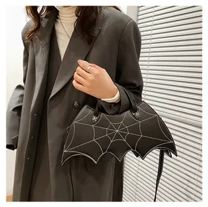 Macro view of gothic bat-shaped PU leather handbag with white spiderweb quilting
