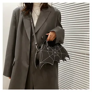 Detailed view of black bat-shaped PU crossbody bag with white spider web embroidery