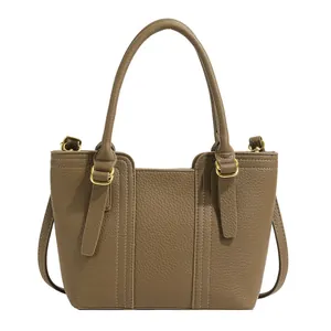 Minimalist khaki brown pebble leather bucket bag with top handle and gold hardware