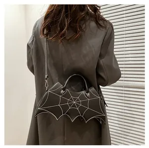 Detail showing the intricate bat wing silhouette and white spider web stitching on the bag