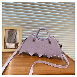 Close-up of light purple bat-shaped Gothic bag with spider web stitching and metal rivets