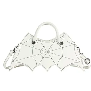 Detailed view of white bat shaped gothic bag with black spider web stitching and spider rivets