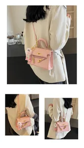 Close-up of pink faux leather handbag with cartoon embossing and fuzzy monster charm