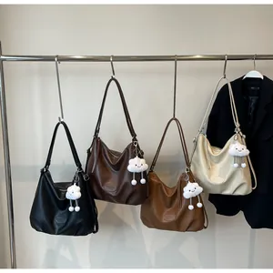 Close-up of four minimalist hobo bags in assorted colors with plush cloud charms