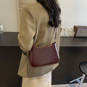 Side view of elegant burgundy leather crescent shoulder bag with NO FILTER logo