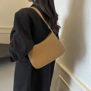 Minimalist brown leather hobo bag for women with adjustable strap and stitching detail