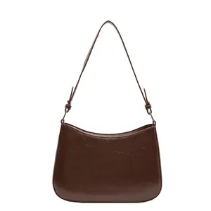 Retro brown crescent shoulder bag in glossy synthetic leather with adjustable strap