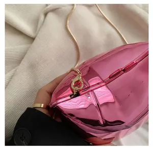 Detail of the golden metal chain hook on the pink heart-shaped metallic evening bag