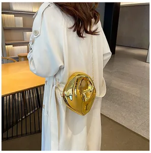 Modern gold irregular-shaped acrylic evening bag with delicate gold chain strap